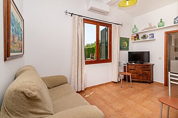 A living room with a couch and a flat screen tv