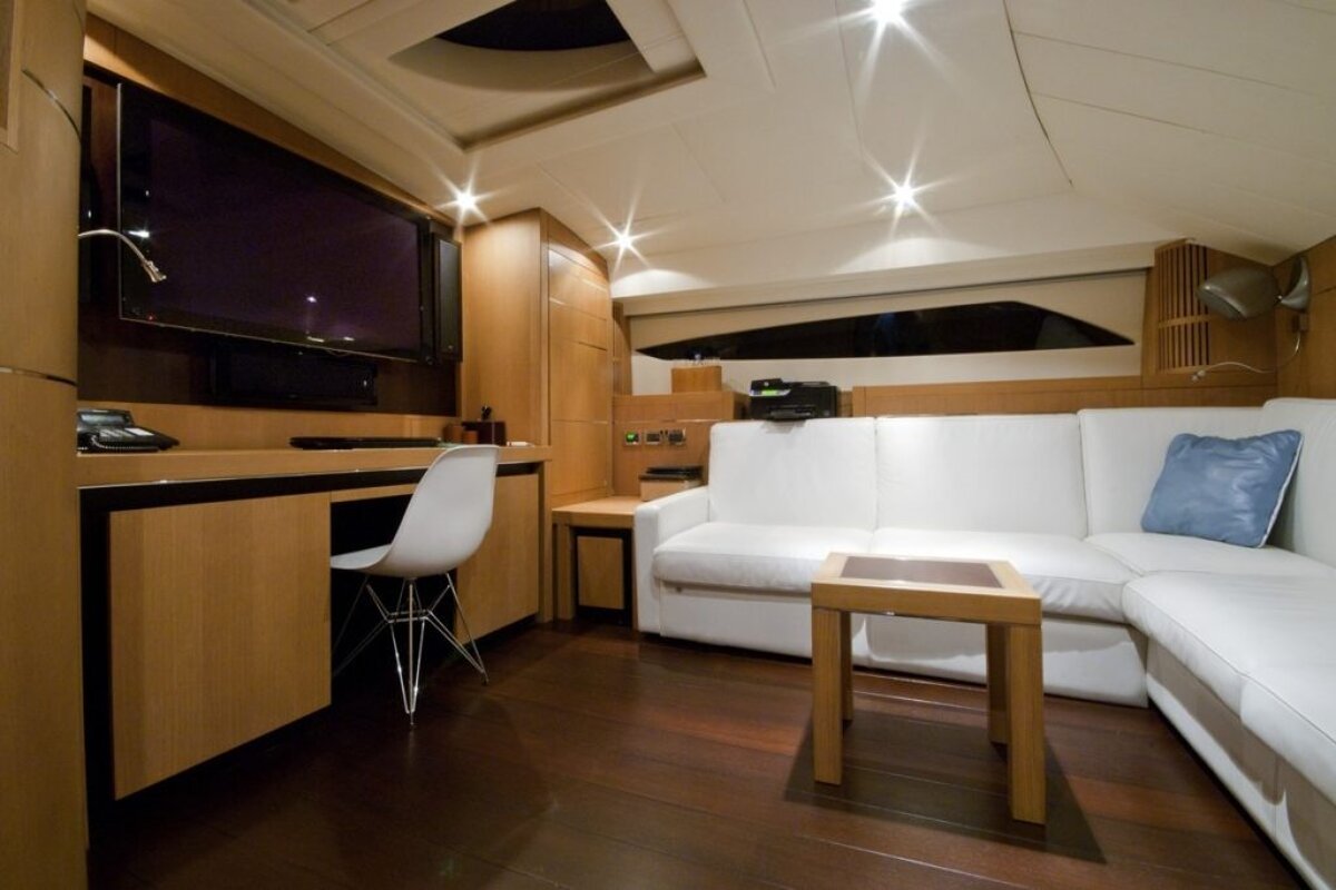 A living room with a white couch and a blue pillow