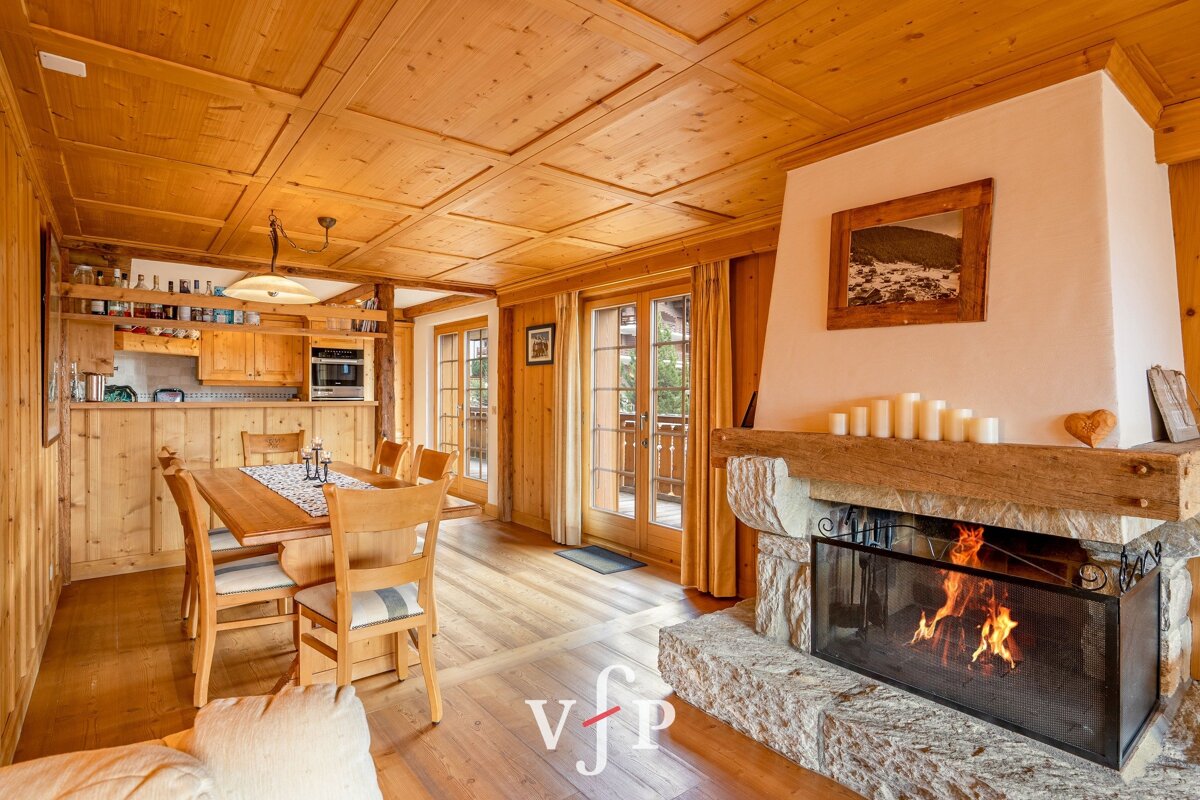 A dining room with a fireplace and a picture on the wall that says vfp