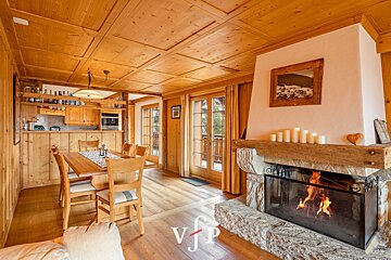 A dining room with a fireplace and a picture on the wall that says vfp
