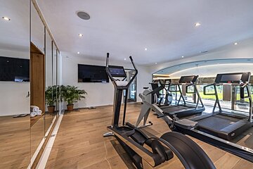 A gym with a treadmill and an elliptical