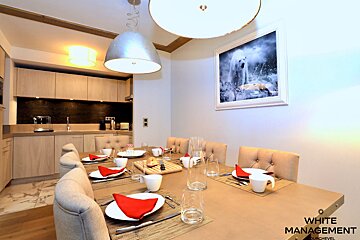 A dining room with a picture of a polar bear on the wall