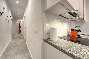 A nespresso machine sits on a counter in a kitchen