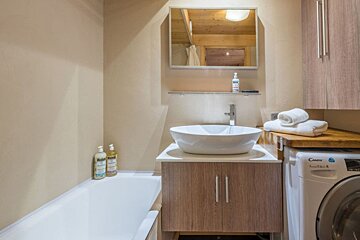 A bathroom with a sink and a candy washing machine