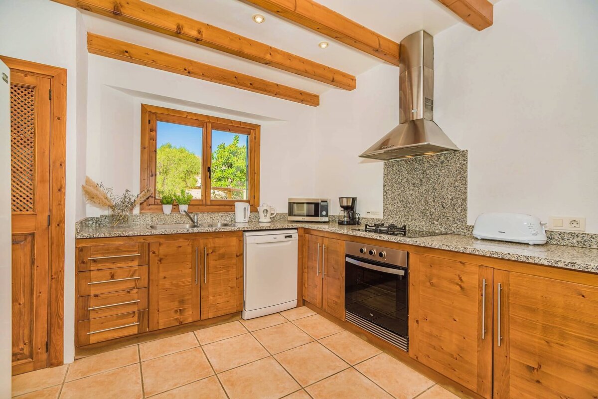 A kitchen with wooden cabinets and granite counter tops