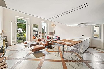 A living room with a brown couch and a wooden table