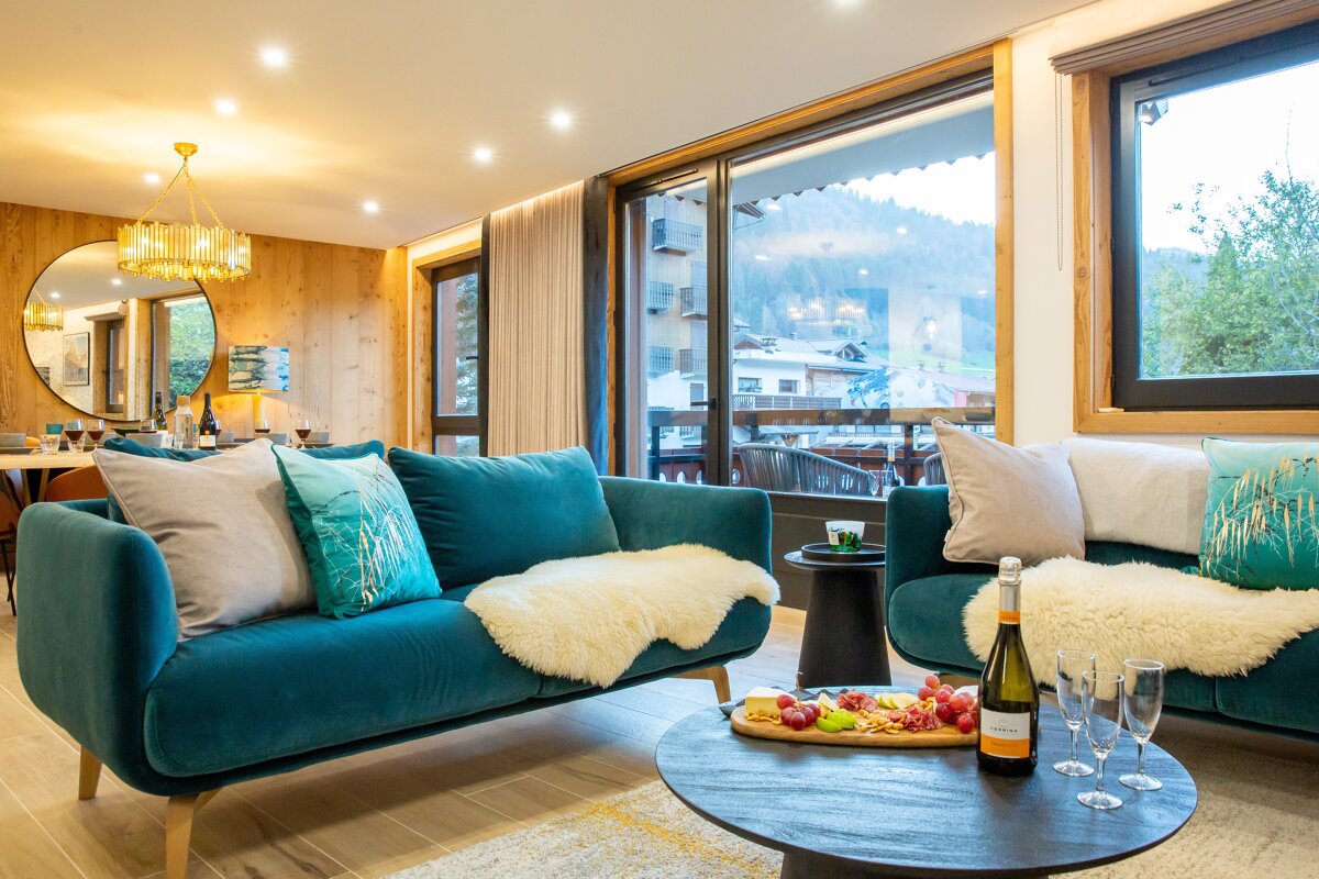 A bottle of champagne sits on a table in a living room
