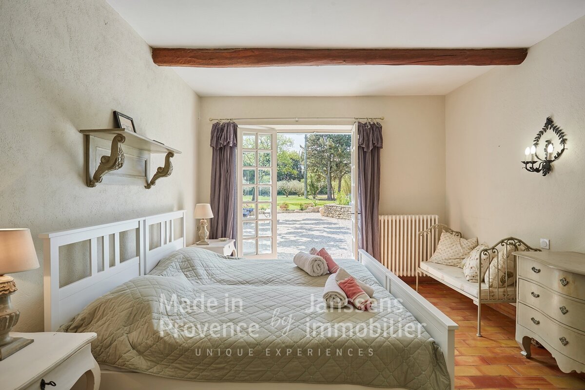 A bedroom with two beds made in provence by janssens immobilier