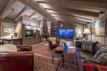 A living room with a couch a chair and a television