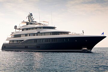 A large black and white yacht with the name explorer on the side