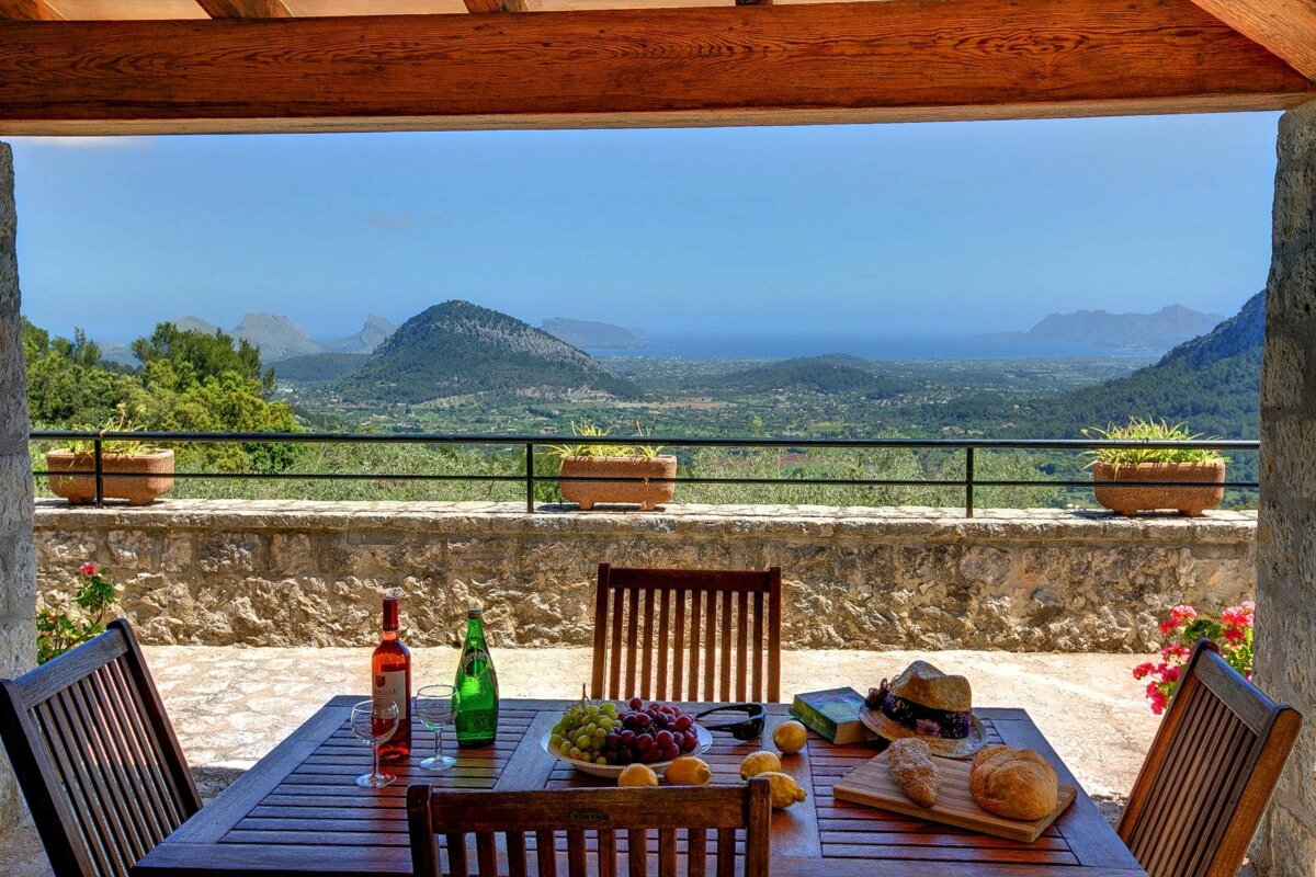 A table with a view of mountains and the ocean