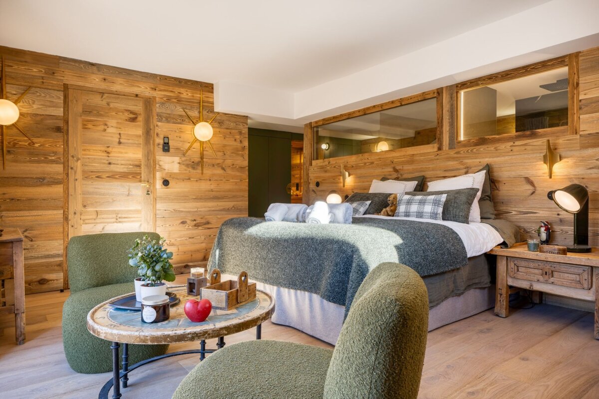 A bedroom with a large bed and a small table