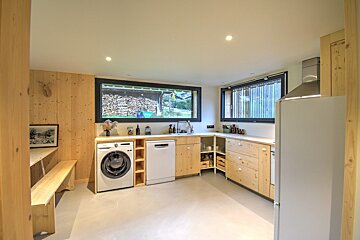 A kitchen with a washing machine and a dishwasher