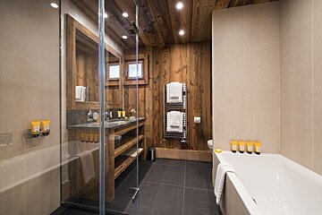 A bathroom with a bathtub a sink and a shower