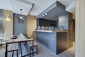 A kitchen with a wooden table and benches