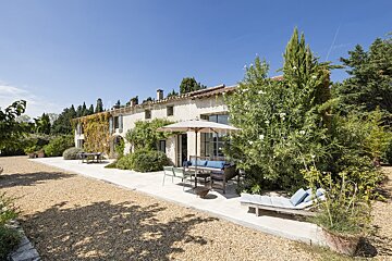 A large house with a patio area in front of it
