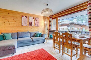 A living room with a couch and a dining table