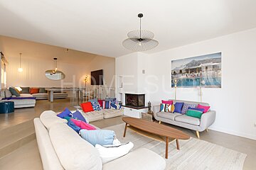 A living room with a painting of a pool on the wall