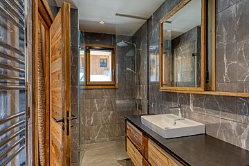 A bathroom with a sink a mirror and a window