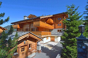 A large wooden house with a lot of balconies