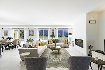 A living room with a couch and chairs and a fireplace