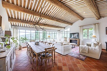 A living room with a wooden table and chairs