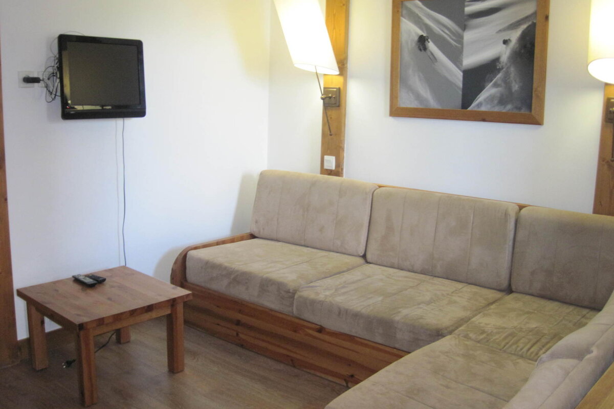 A living room with a couch and a flat screen tv