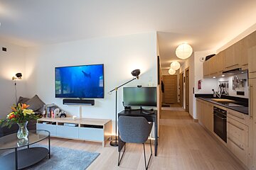 A living room with a flat screen tv on the wall