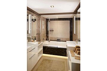 A bathroom with two sinks and a bathtub