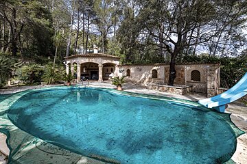 A large swimming pool with a slide in it