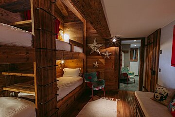 A bedroom with bunk beds and a star on the wall