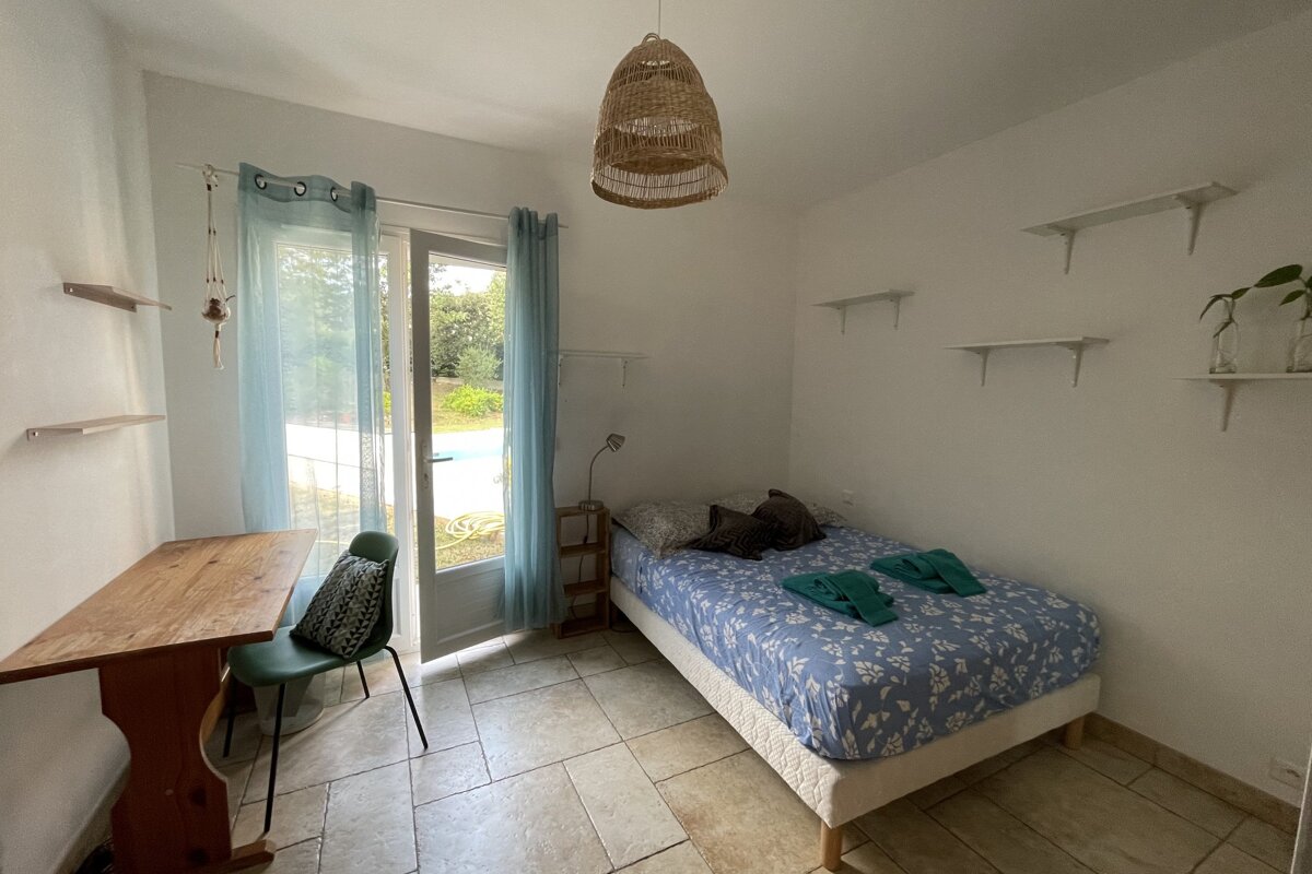 A bedroom with a single bed and a desk