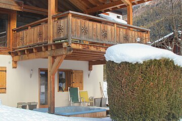 A wooden balcony with snowflakes on it
