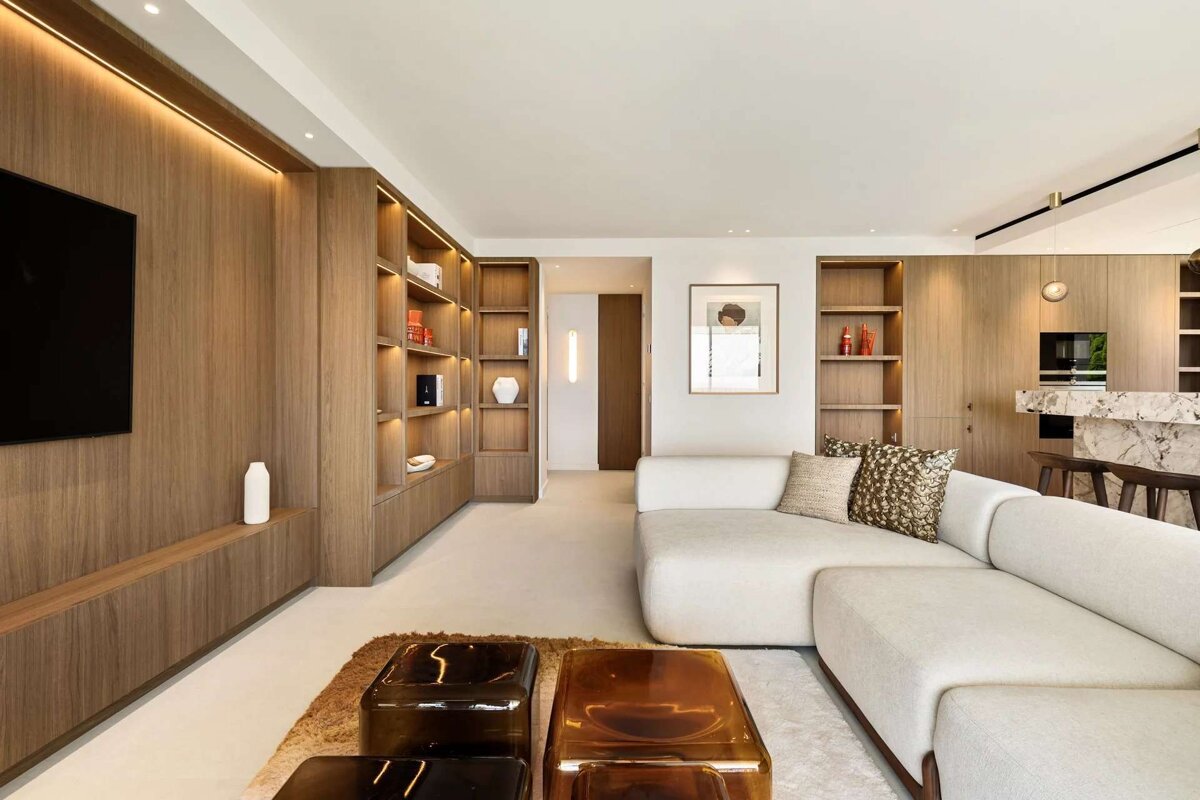 A living room with a sectional couch and a flat screen tv