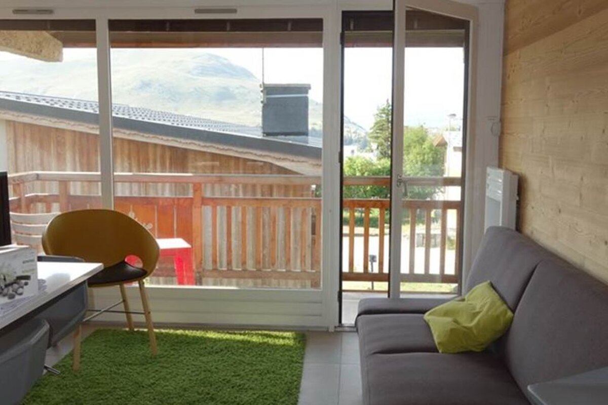 A living room with a couch a chair and a television