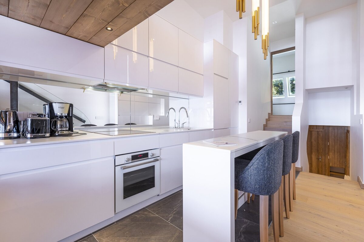A kitchen with white cabinets and a russell coffee maker