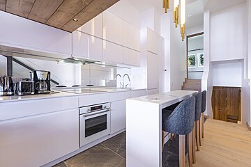 A kitchen with white cabinets and a russell coffee maker