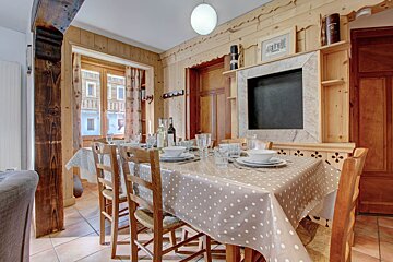 A dining room table with a polka dot table cloth