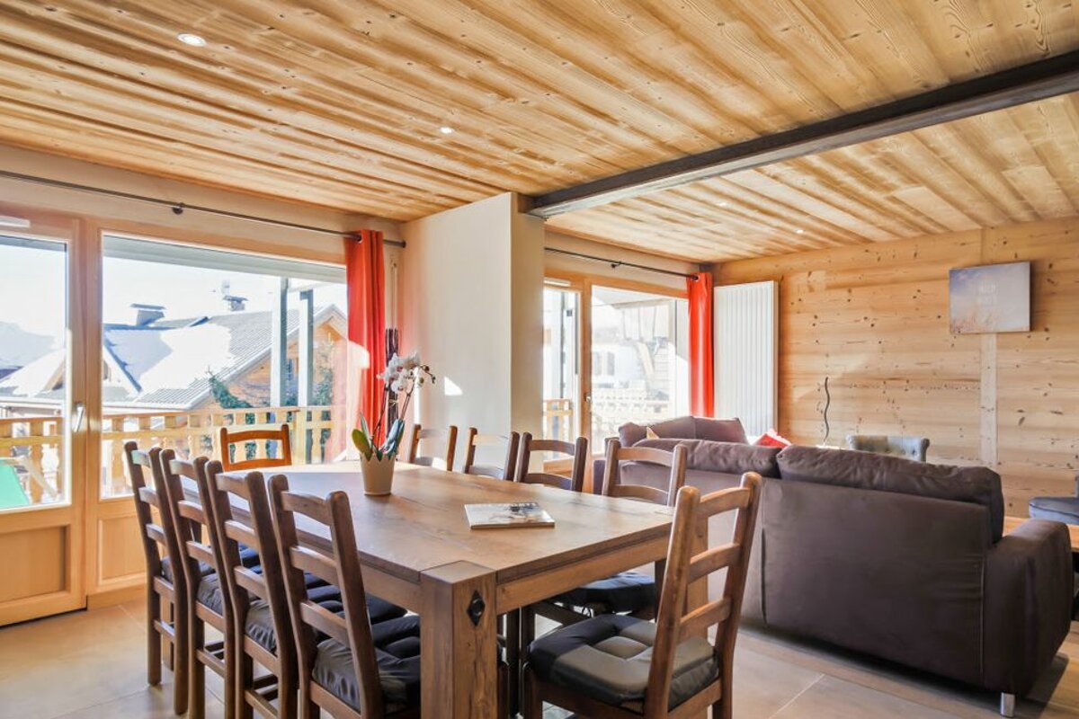 A living room with a dining table and chairs