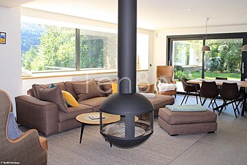 A living room with a fireplace and the word holidays on the wall
