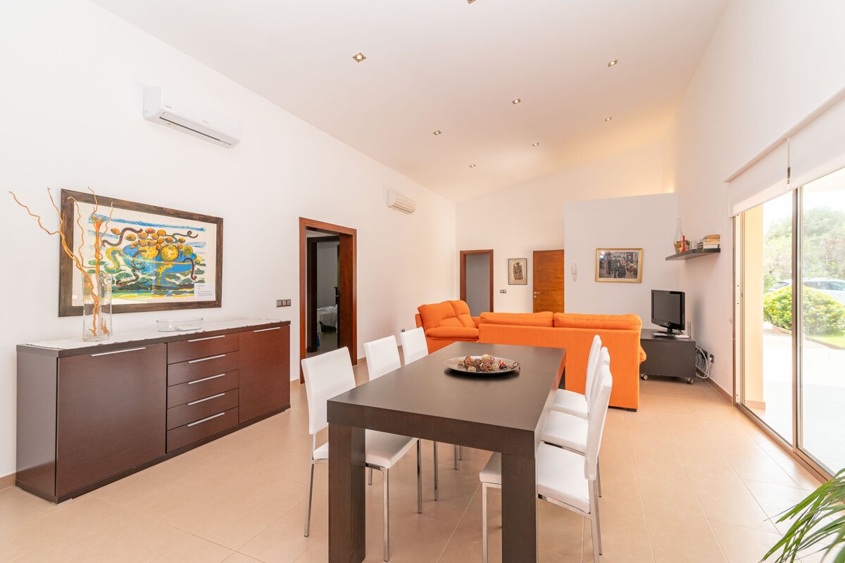 A living room with a dining table and chairs