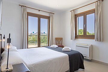 A bathroom with a toilet and a shower stall