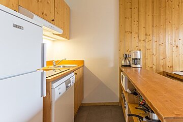 A kitchen with a fridge that says leeds on it