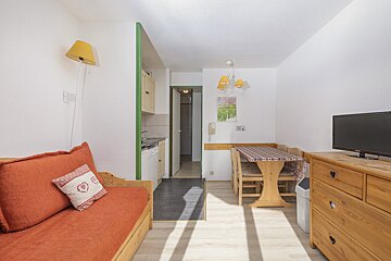 A living room with a couch a table and a television