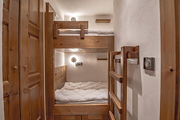 A bunk bed with a ladder leading up to it