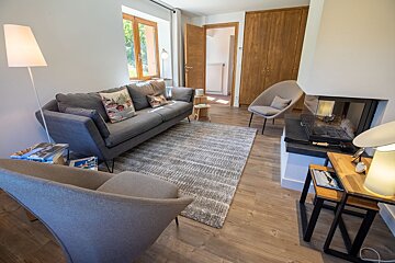 A living room with a couch a chair and a fireplace