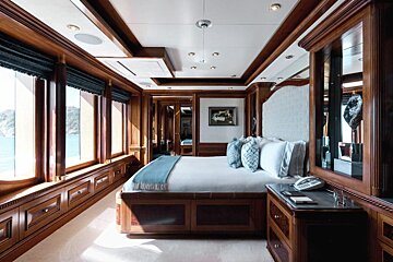 A bedroom with a large bed and a phone on the nightstand