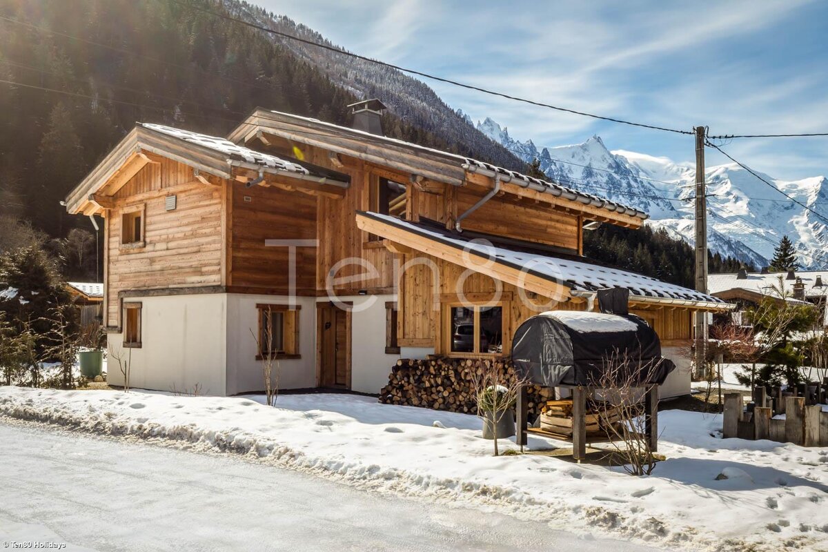 A snowy house with the word ten on the side