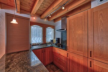 A kitchen with wooden cabinets and granite counter tops