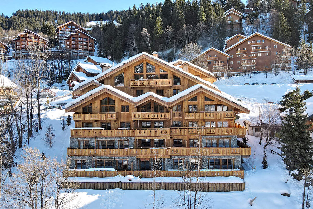 A large building with a lot of windows is covered in snow